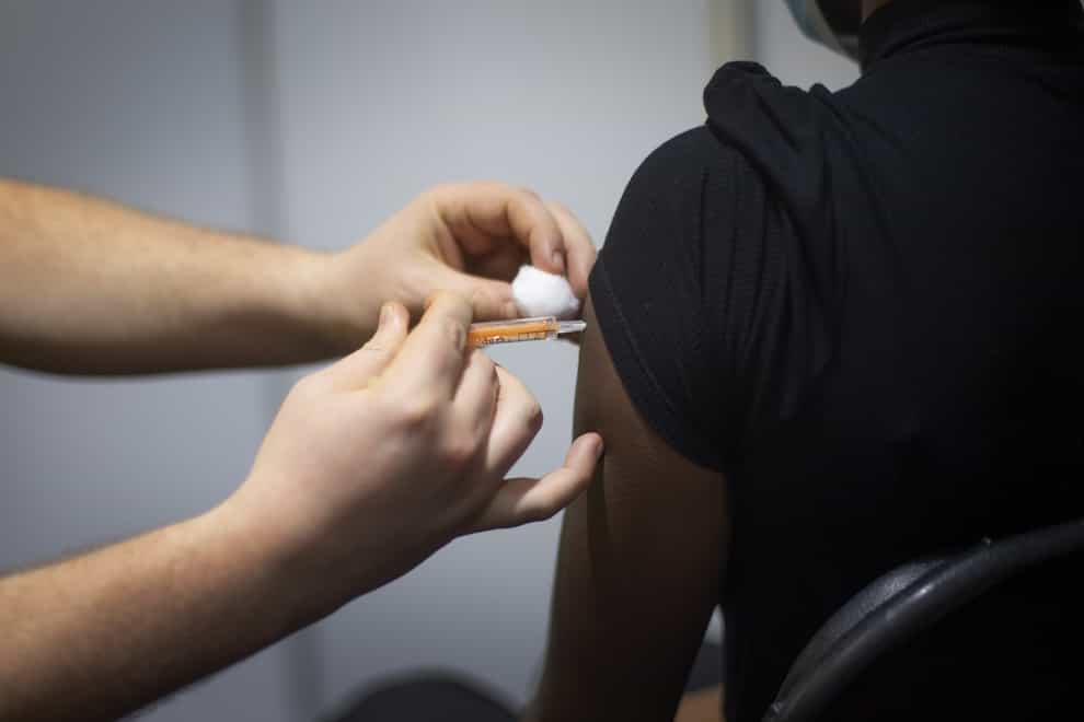 A woman receives an injection of the COVID-19 vaccine
