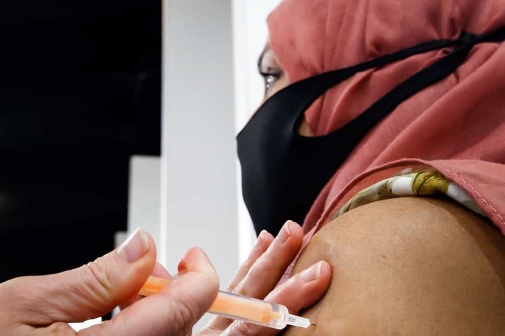 A woman receives an injection of the the Oxford/AstraZeneca coronavirus vaccine (PA)