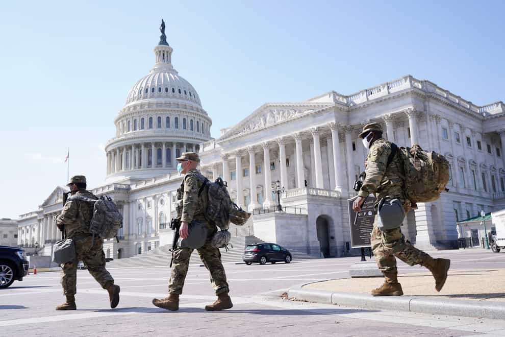National Guard members walk near the Capitol (Jacquelyn Martin/AP)