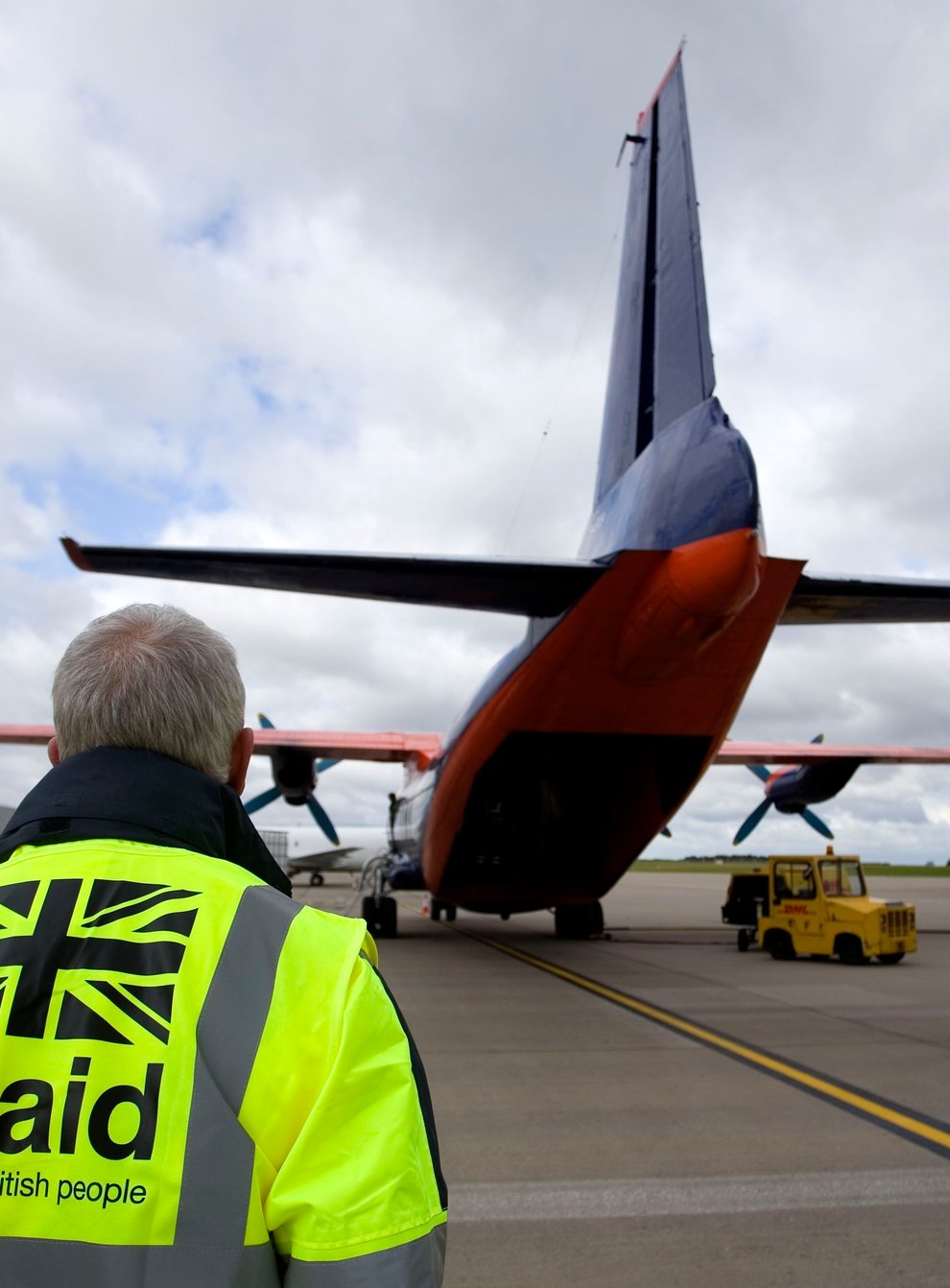 Staff from UK Aid watch as cargo is loaded on to an Antonov An-12B aircraft at East Midlands Airport (Simon Cooper/PA)