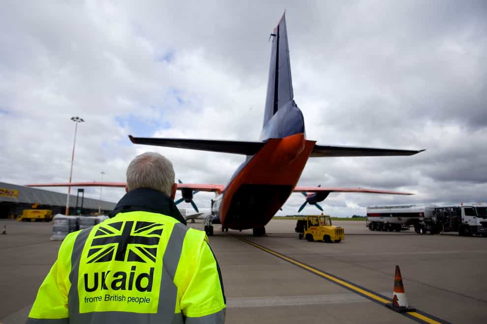 Staff from UK Aid watch as cargo is loaded on to an Antonov An-12B aircraft at East Midlands Airport (Simon Cooper/PA)