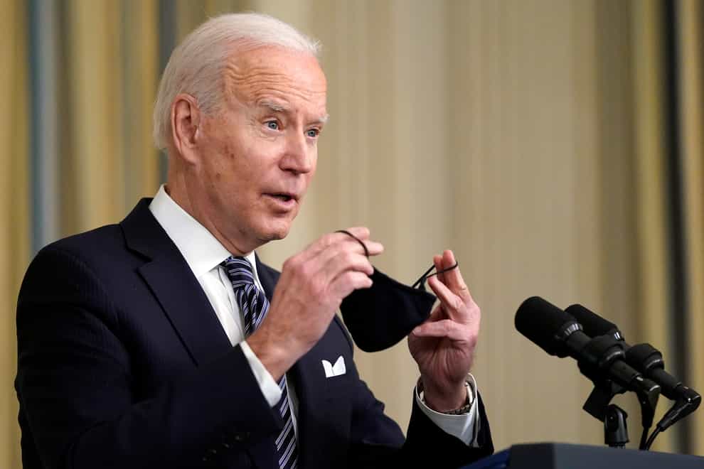 President Joe Biden puts his face mask on