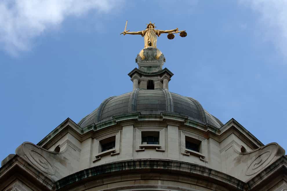 View of the gold statue of the figure of justice, holding scales and a sword, on top of the Central Criminal Court, also referred to as Old Bailey (Clara Molden/PA)