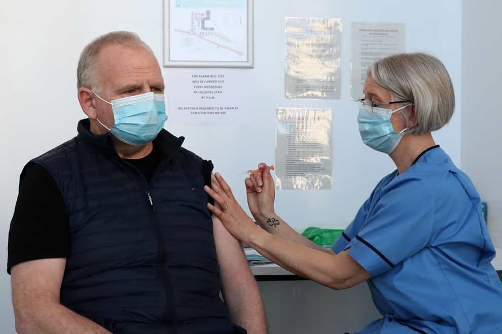 Man being vaccinated by an NHS worker