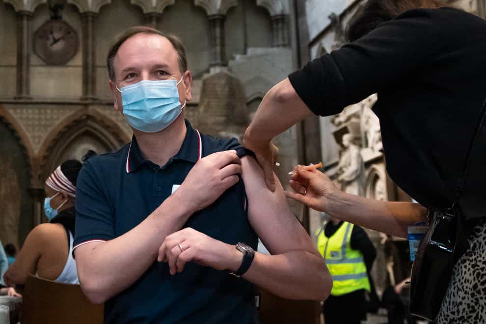 Dr Jan Maniera administers an injection of the AstraZeneca coronavirus vaccine to chief executive of the NHS Sir Simon Stevens at Westminster Abbey, London (Aaron Chown/PA)