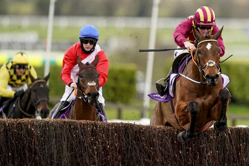 Minella Indo, ridden by Jack Kennedy (right), clears the last on his way to winning the WellChild Cheltenham Gold Cup Chase