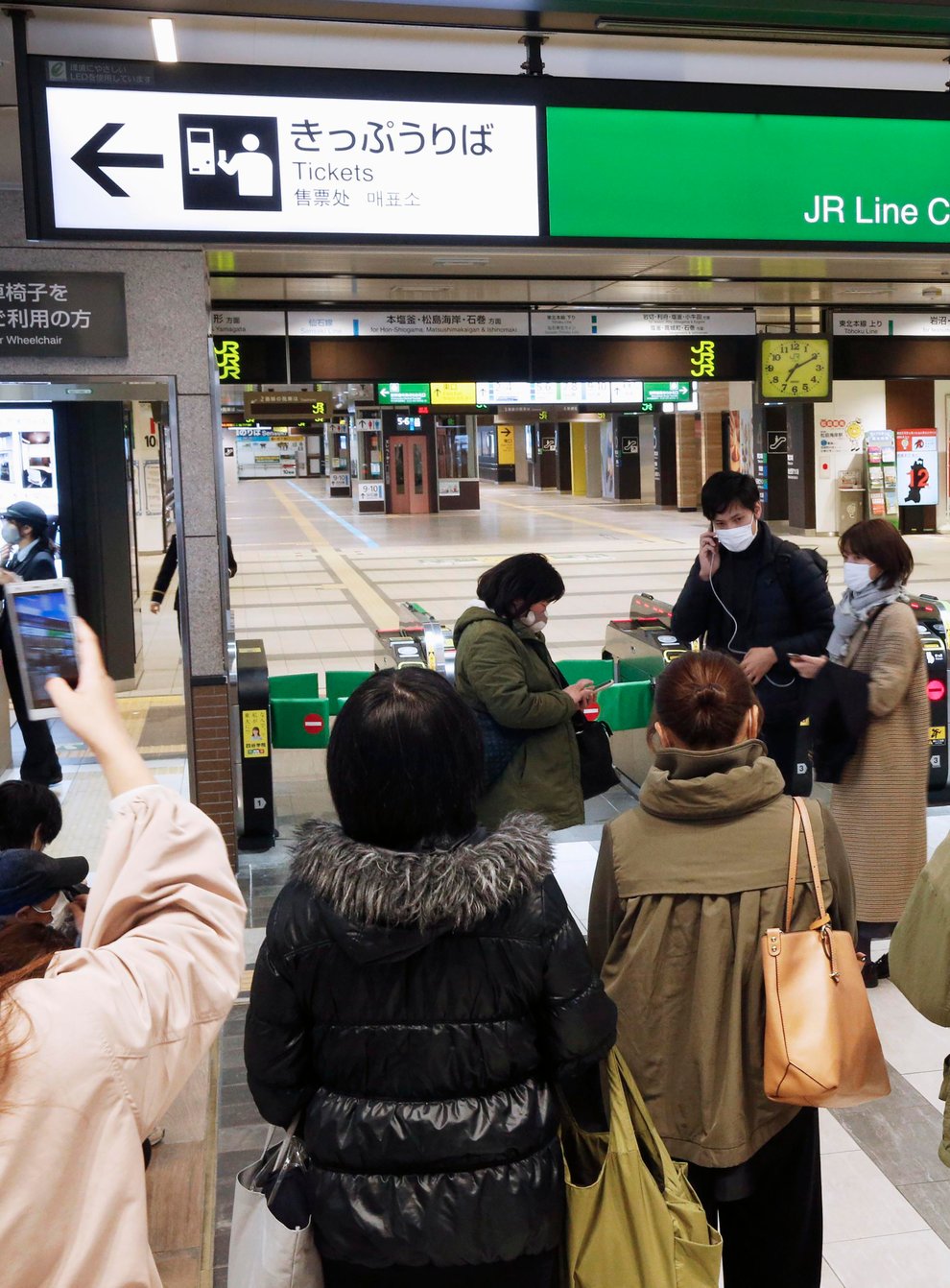 People at a train station after the quake in Japan
