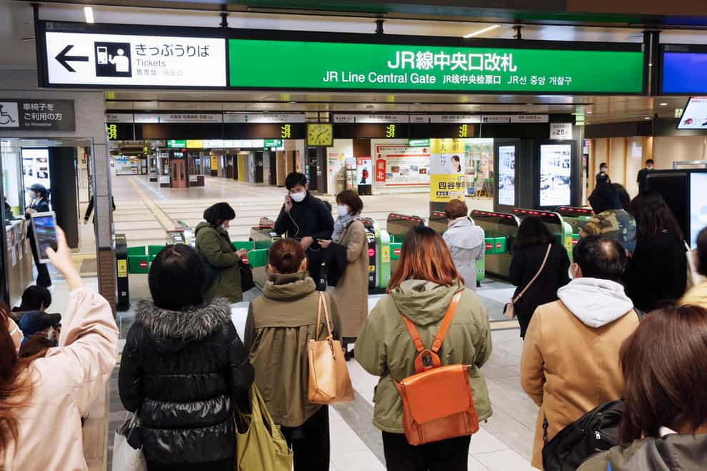 People at a train station after the quake in Japan