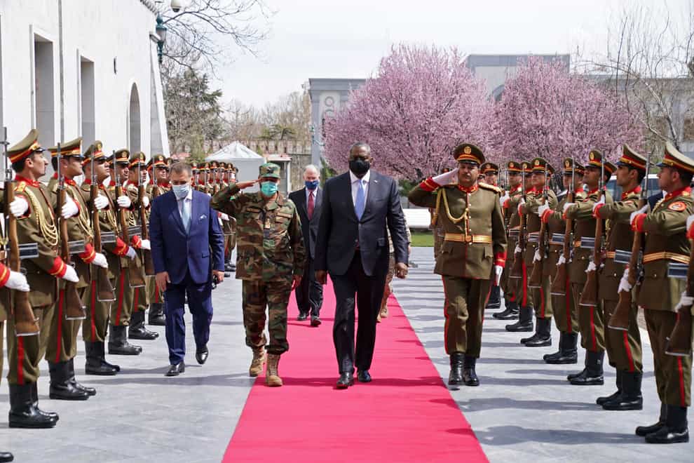 US Defence Secretary Lloyd Austin walks with Acting Afghan Minister of Defence Yasin Zia as they review an honour guard at the presidential palace in Kabul (Presidential Palace via AP)