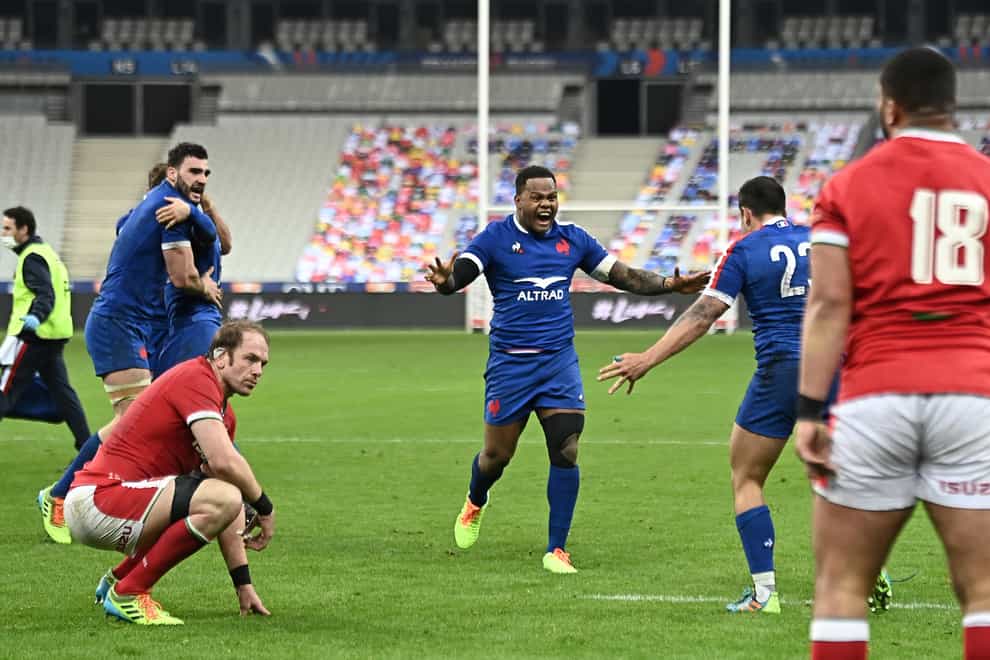 France’s Virimi Vakatawa (centre) celebrates as Wales’ Alun Wyn Jones (left) sits dejected after the Guinness Six Nations match at Stade de France