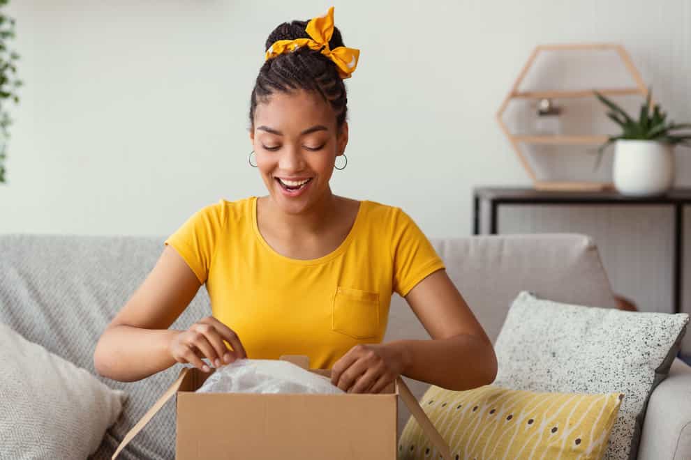Woman opening a parcel and looking delighted