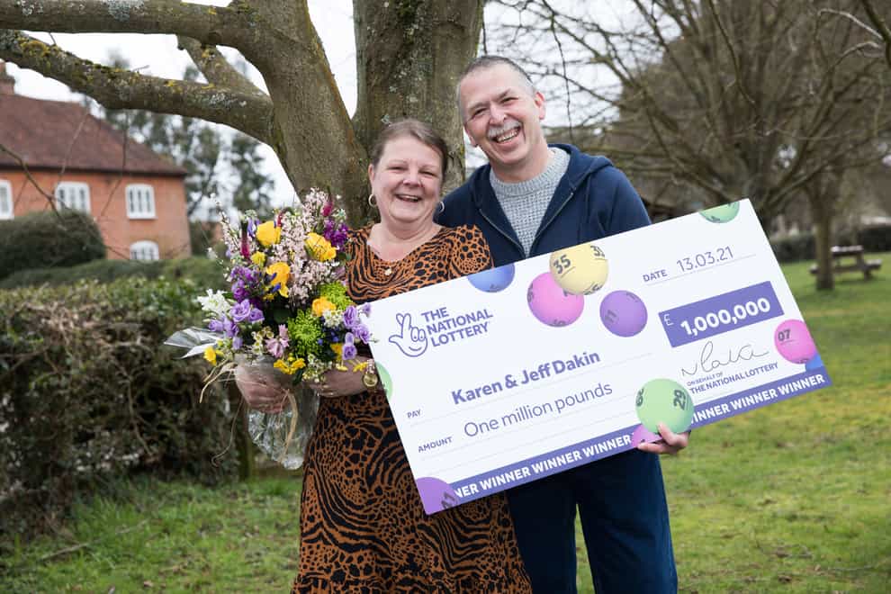 School dinner lady Karen Dakin celebrates with her husband Jeff after winning £1 million on the lottery