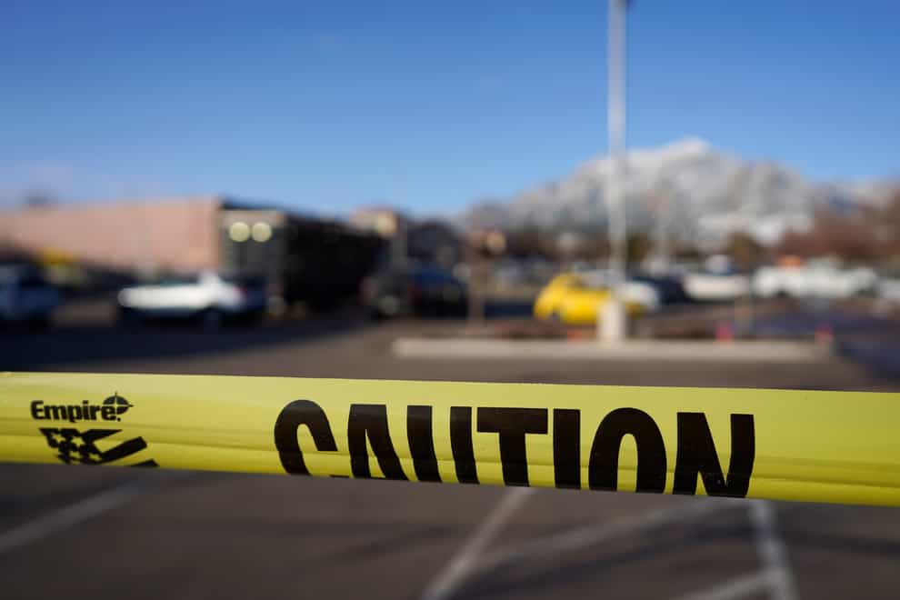 Police tape marks the car park outside the supermarket where the shooting took place