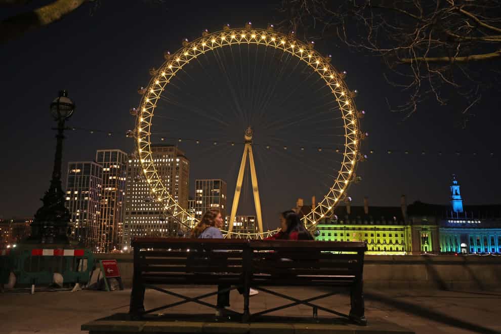 London Eye lit up yellow on Day of Reflection