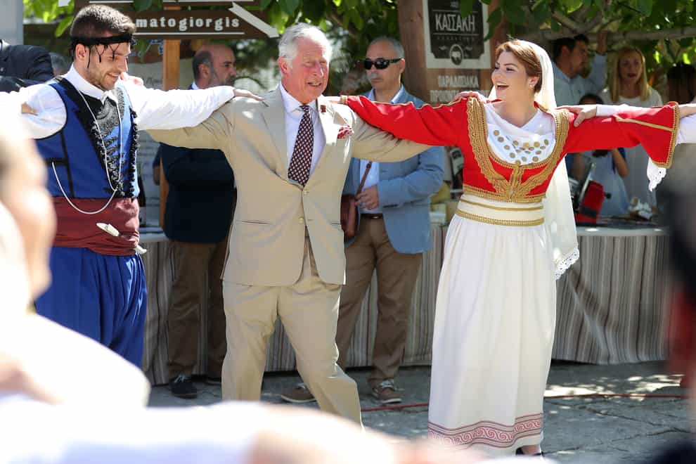 The Prince of Wales tries his hand at Greek dancing