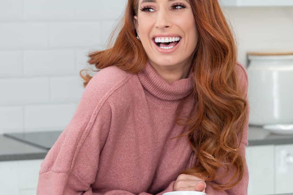 Stacey Solomon in a pink jumper at home, laughing and happy
