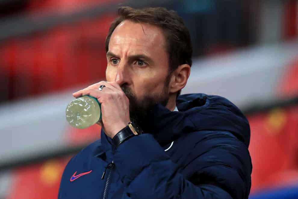 Gareth Southgate drinks water on the touchline