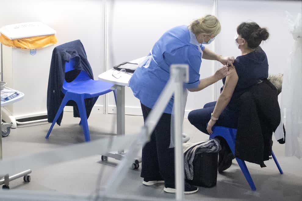 A nurse administers a coronavirus vaccine