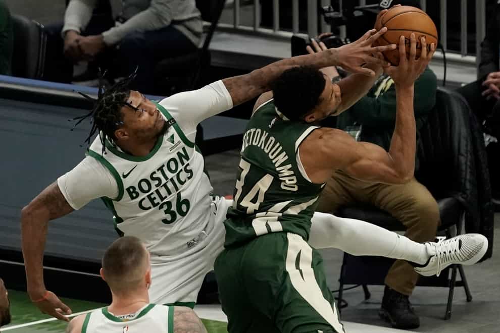 Boston Celtics’ Marcus Smart fouls Milwaukee Bucks’ Giannis Antetokounmpo