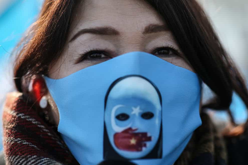 A protester from the Uighur community living in Turkey, participates in a protest in Istanbul (Emrah Gurel/AP)