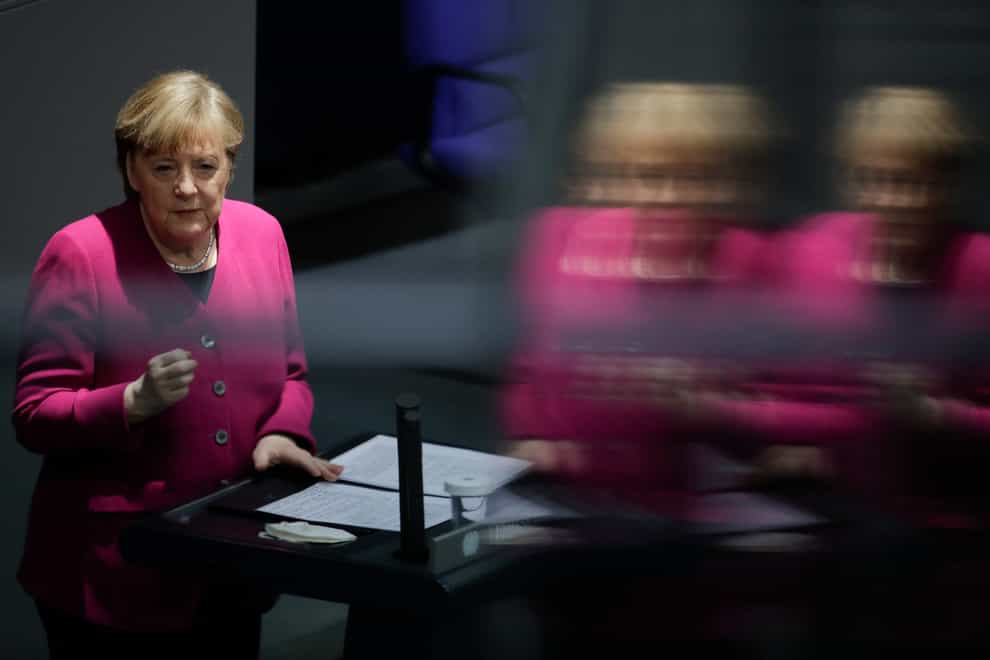 German Chancellor Angela Merkel addresses the German parliament Bundestag ahead of an European Union summit at the Reichstag building (Markus Schreiber/AP)