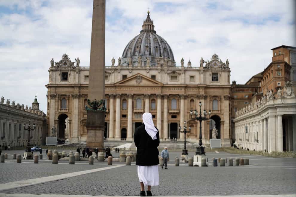 A nun stands in St Peter’s Square at the Vatican (Gregorio Borgia/AP)