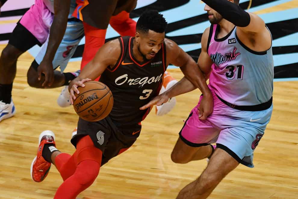 Portland Trail Blazers guard CJ McCollum drives as Miami Heat guard Max Strus defends
