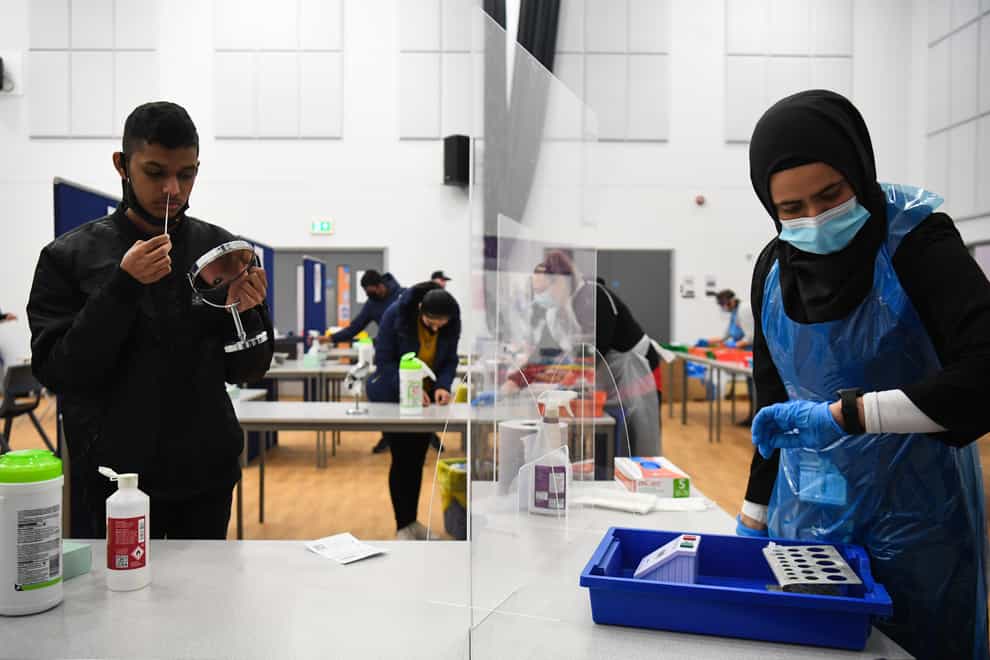 A student takes a Covid-19 test at Hounslow Kingsley Academy in West London (PA graphic)