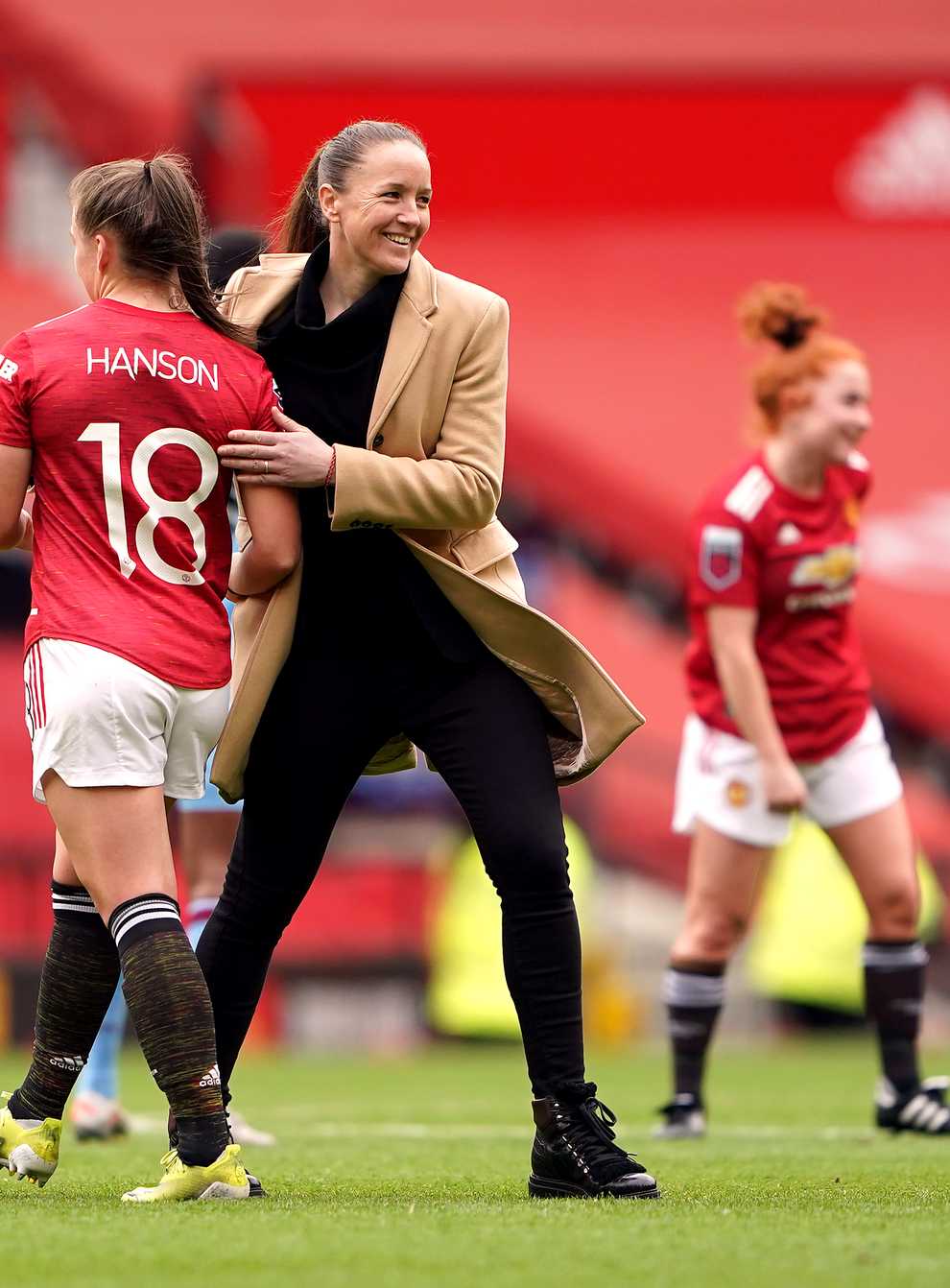 Casey Stoney congratulates her players after Manchester United Women's first match at Old Trafford