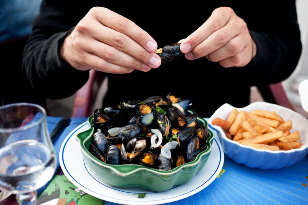 Man eating mussels