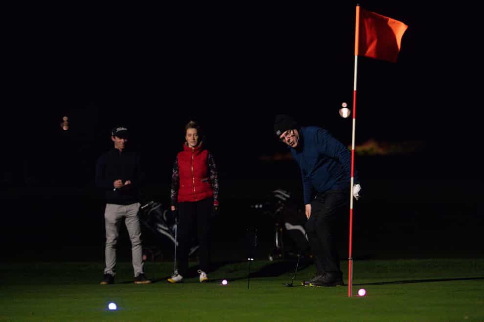Golfers use neon coloured balls under floodlights at Morley Hayes Golf centre