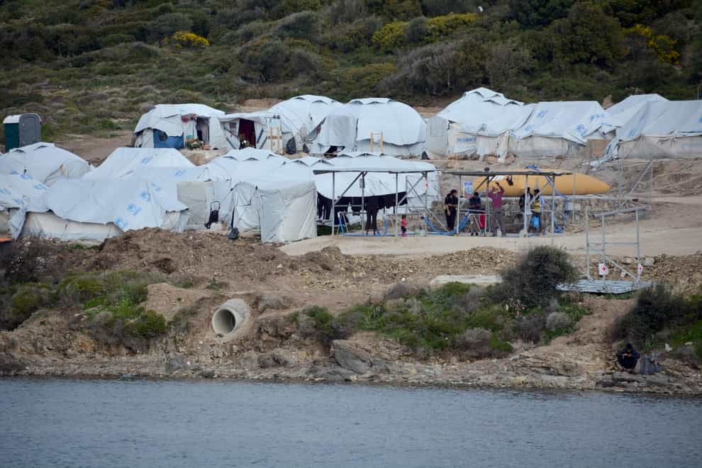 Migrants gather outside their tents at Karatepe refugee camp, on the eastern Aegean island of Lesbos, Greece (Panagiotis Balaskas/AP)