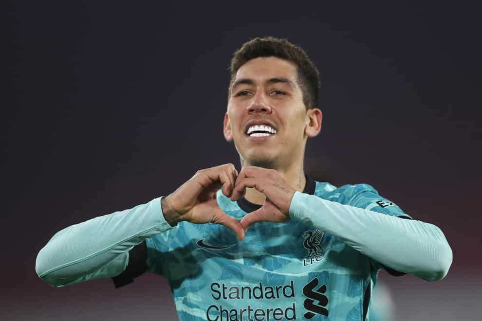 Liverpool forward Roberto Firmino makes a heart shape with his hands after scoring