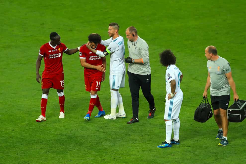 Liverpool’s Mohamed Salah is consoled by Real Madrid’s Sergio Ramos after his injury in the 2018 Champions League final