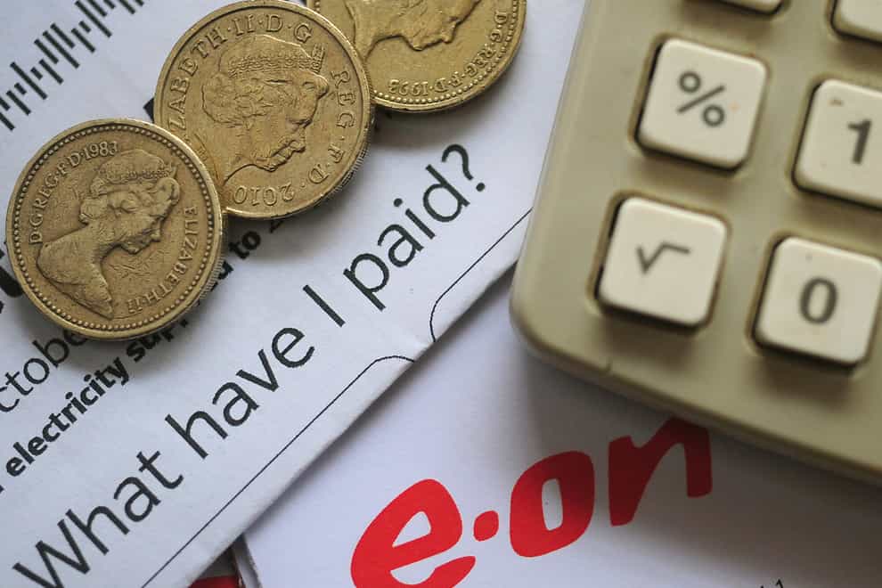 An EON energy bill with pound coins and a calculator