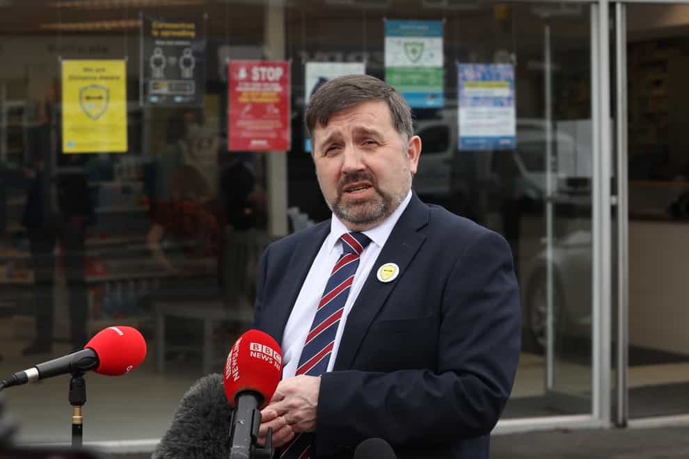 Minister for Heath, Robin Swann, speaks to the media outside Timoney Pharmacy in Lambeg (Liam McBurney/PA)