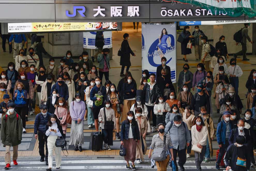People wear face masks as they make their way in Osaka, western Japan