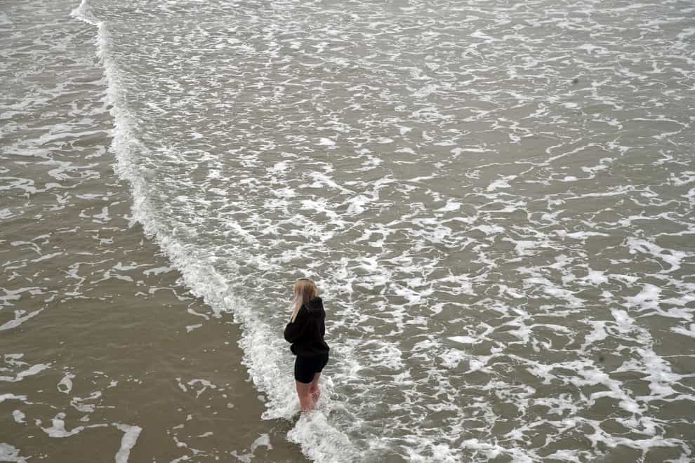 Woman paddles in sea
