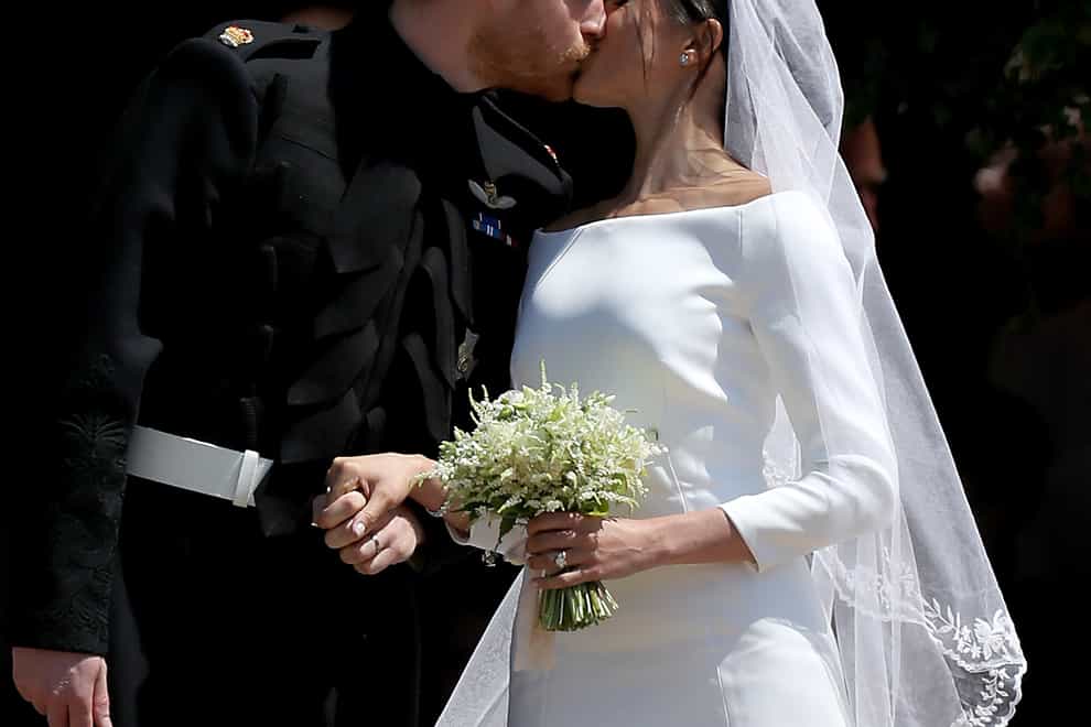 Prince Harry and Meghan Markle kiss outside St George’s Chapel in Windsor Castle after their wedding