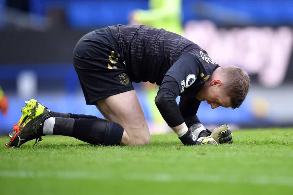 Everton goalkeeper Jordan Pickford kneels on all fours