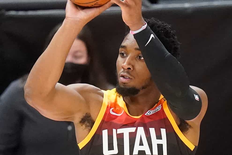 Utah Jazz guard Donovan Mitchell shoots a three-point basket against the Orlando Magic