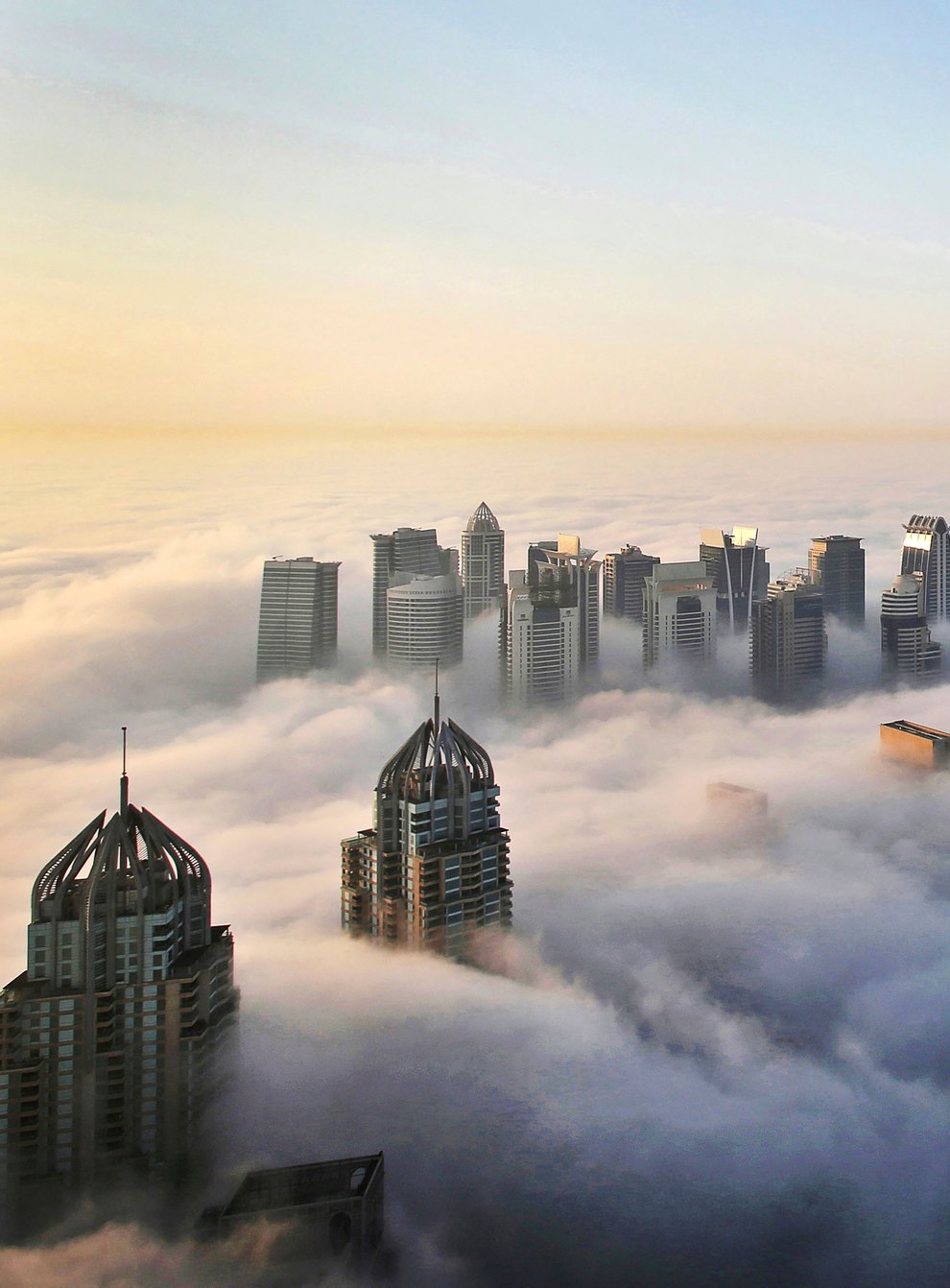A thick blanket of early morning fog partially shrouds the skyscrapers of the Marina and Jumeirah Lake Towers districts of Dubai, United Arab Emirates (Kamran Jebreili/AP)