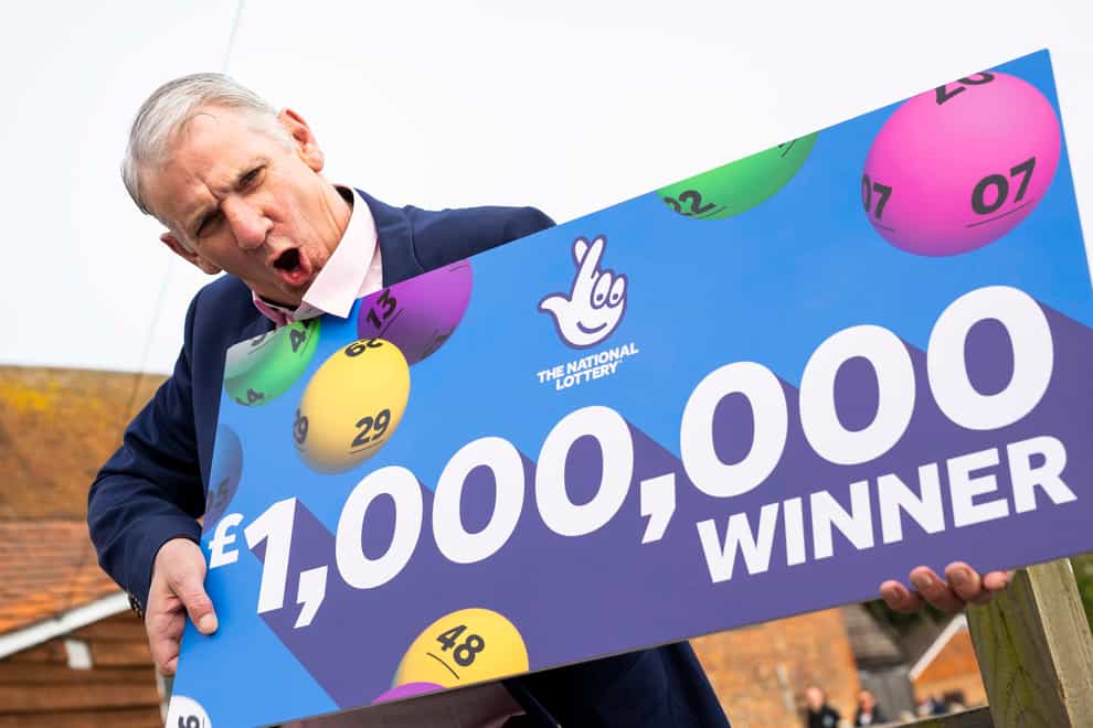 John McFadden from Southampton celebrates winning £1m on a National Lottery scratchcard