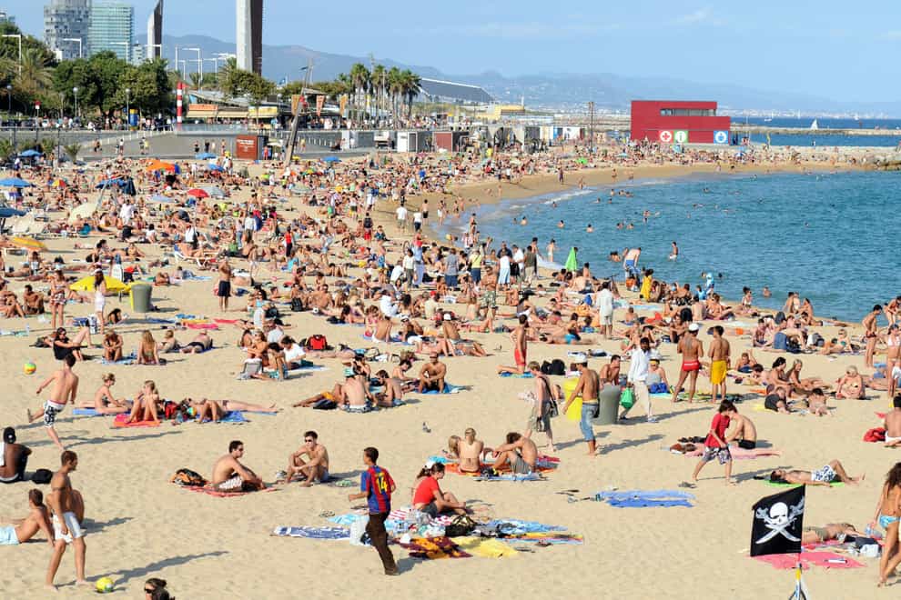 Holidaymakers on Platja Nova Icarie beach in Barcelona, Spain