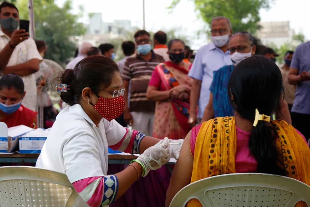 A health worker administers a vaccine in India