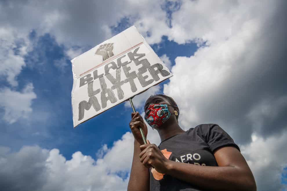 A woman holding a banner during in a Black Lives Matter protest rally at Woodhouse Moor in Leeds (Danny Lawson/PA)