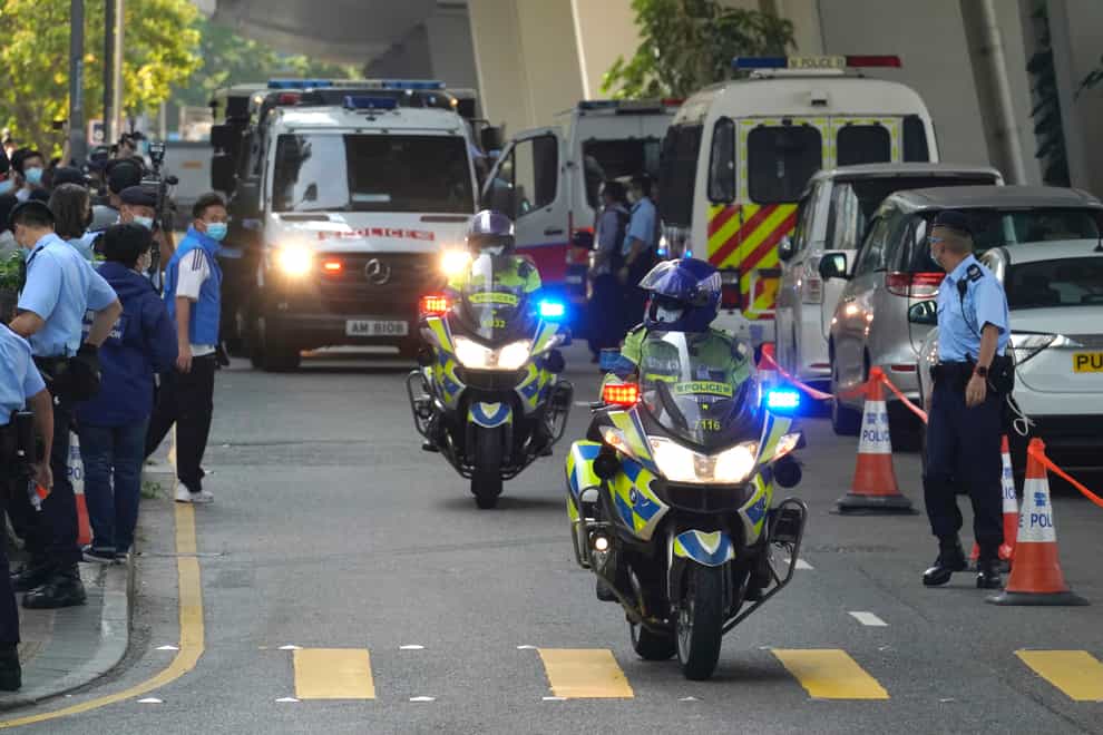 Police officers escort a prison van carrying Hong Kong pro-democracy activist Andy Li as it is leaving court in Hong Kong (Kin Cheung/AP)