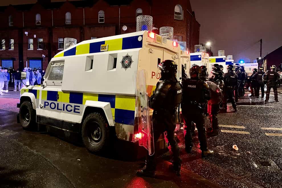 PSNI officers and Land Rovers on the nationalist side of the Springfield Road in Belfast (Liam McBurney/PA)