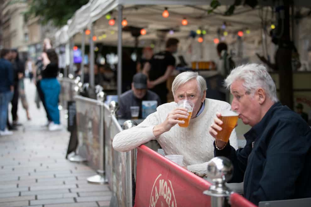 Members of the public enjoy their first drink in a beer garden in Scotland