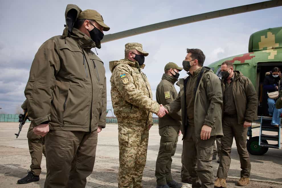 Ukrainian President Volodymyr Zelenskiy shakes hands with a soldier as he visits the war-hit Donetsk region (AP)